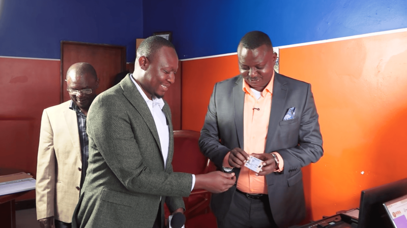 Pr Bujjingo Receives New National ID, NIRA Officials Encourage Public Registration